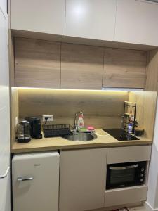 a small kitchen with a sink and a stove at Smart Home , Lovely Apartment in Tirana in Tirana +20 photos