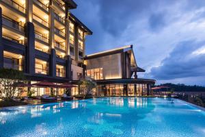 a large swimming pool in front of a building at Pullman Yuxi in Yuxi