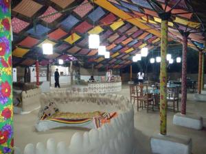 a large tent with a bed in the middle of a room at Shaam E Sarhad Resort in Bherandiāla