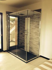 a glass shower in the corner of a room at Gl106 in Santa Severa