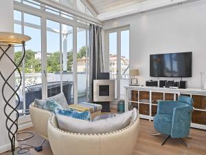 a living room with a couch and chairs and a tv at Villa Johanna in Sellin - Penthouse "Nautilus" in Ostseebad Sellin +24 photos