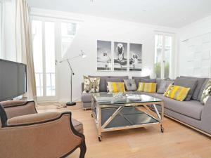 a living room with a couch and a coffee table at Villa "Johanna" Sellin - WG12 mit Kamin und zwei Balkonen in Ostseebad Sellin
