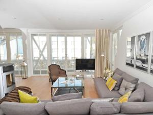 a living room with a couch and a table at Villa "Johanna" Sellin - WG12 mit Kamin und zwei Balkonen in Ostseebad Sellin