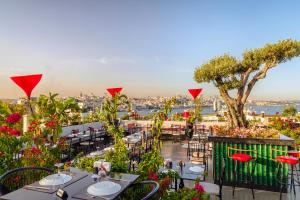 a restaurant with tables and chairs and a view of the city at Seres Hotel Old City in Istanbul