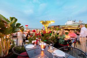 a group of people sitting at tables on a patio at Seres Hotel Old City in Istanbul