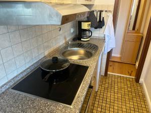 a kitchen counter with a sink and a sink at Capt'n Cook 2 in Nordstrand