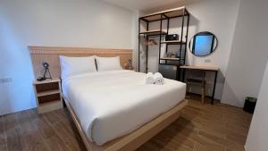 a bedroom with a large white bed and a mirror at B3 HOUSE in Kamala Beach +35 photos