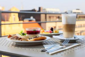 two plates of food on a table with a drink at Amarilis in Prague +75 photos