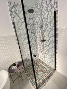 a shower with a glass door in a bathroom at Deluxe Apartment #CasaMihai Free Parking in Braşov