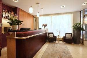 a lobby with a bar with chairs and a window at Amarilis in Prague