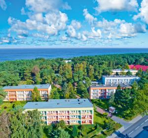an overhead view of a building with trees and the ocean at Rewita Rogowo k Kołobrzegu in Rogowo