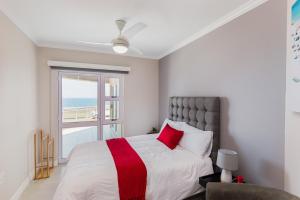 a bedroom with a large bed and a window at Les Dauphine 13 in Ballito