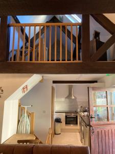 a kitchen with a staircase and a living room at The Radnor Arms in Malmesbury