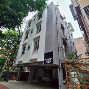 a building with a sign on the side of it at Sharman Suites in Pune