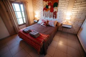 a bedroom with a bed and a brick wall at Departamento Minimalista in San Rafael