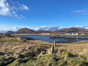 a view of a river with mountains in the background at Kilda House in Leverburgh