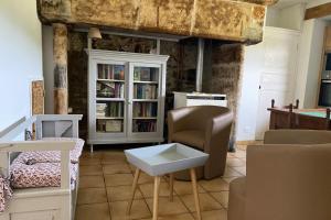 Gîte à Rocamadour في روكامادور: غرفة معيشة مع كرسي وطاولة