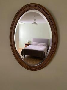 a bedroom with a bed and a mirror on the wall at Gîte à Rocamadour in Rocamadour