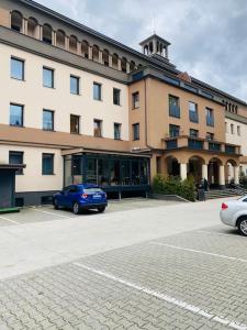 a building with a blue car parked in front of it at Residence Park lovely apartman with private parking in Kysucké Nové Mesto