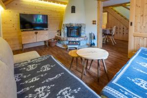 a living room with a couch and a fireplace at ALPIK Chalets - Bohinj in Bohinj
