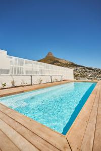 a swimming pool on top of a building at Home Suite Hotels Station House in Cape Town
