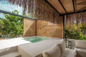 a hot tub in a patio with aitating at Ultava Houses in Datca