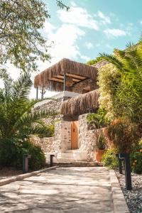 a stone house with a straw roof at Ultava Houses in Datca