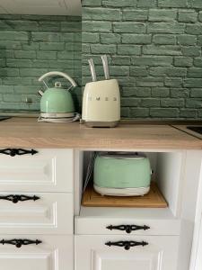 two toasters and a toaster sitting on a shelf at Classic and New brand Apartment San Stefano 9 in Varna City +10 photos