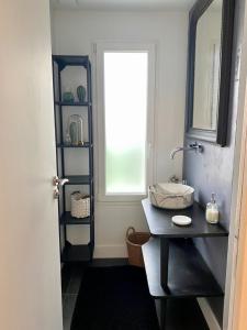 a bathroom with a sink and a window at Proche centre ville, gîte 4 étoiles avec piscine in Dijon +25 photos