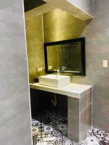 a bathroom with a sink and a mirror at Palazzo 1 HotSpring,3Bedrooms 35to40pax, Pansol Calamba in Pansol