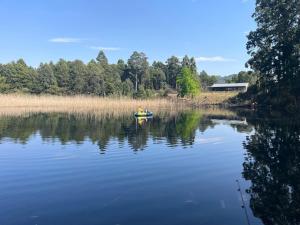 two people in a boat on a lake at Hum Lilly in Balgowan