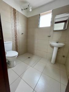 a bathroom with a toilet and a sink at Edificio Las Palmas 3100 in Santa Cruz de la Sierra