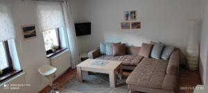 a living room with a couch and a table at ubytovanie CITY apartmán in Martinske Hole