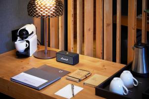 a desk with a lamp and a coffee maker on it at Park Piolets MountainHotel & Spa in Soldeu