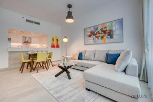 a living room with a couch and a table at Ideal 1BR at Marina Quay West Dubai Marina by Deluxe Holiday Homes in Dubai