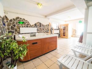 a bathroom with a sink and a stone wall at Pensjonat Szczepaniakówka in Niedzica Zamek