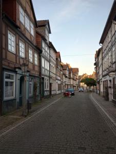 a cobblestone street in an old town with buildings at Damm 10 Appartement in Peine