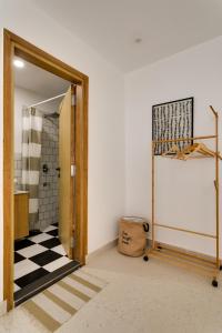 a bathroom with a black and white checkered floor at Vaara in New Delhi