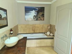 a bathroom with a tub and a sink at Kosi Bay Lake House in KwaMazambane +52 photos