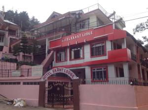 a red and white building with a sign on it at Hotel Ekant Lodge in McLeod Ganj