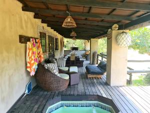 a patio with a hot tub on a deck at Kosi Bay Lake House in KwaMazambane