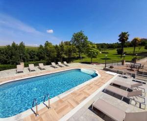 a swimming pool with lounge chairs and a swimming pool at Rosso Di Sera in Novello