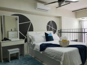 a bedroom with a bed with a bowl of fruit on it at The Perfect Getaway @ Tamarind Suites, Netflix 300Mbps in Cyberjaya