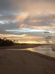 a sunset on a beach with the ocean at Casa Teodoro!!! in Trairi