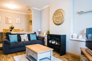 a living room with a couch and a fireplace at Mumbles Apartment near to shops and beach in The Mumbles