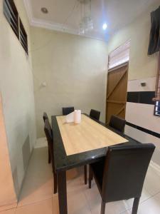 a dining room table and chairs in a room at Homestay lagenda padang serai in Padang Serai