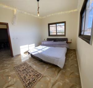 a bedroom with a large bed in a room at Nabati hostel in Wadi Musa
