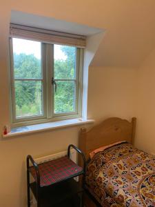 a bedroom with a bed and a window at Cotswolds house in Cirencester