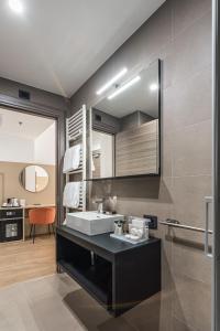 a bathroom with a sink and a mirror at BB Hotels Smarthotel Duomo in Milan