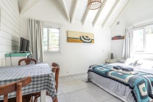 a bedroom with a bed and a tv at Nautilus B&B in Pinamar +90 photos